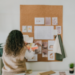 Woman looking at a board with papers and fabric to identify trends